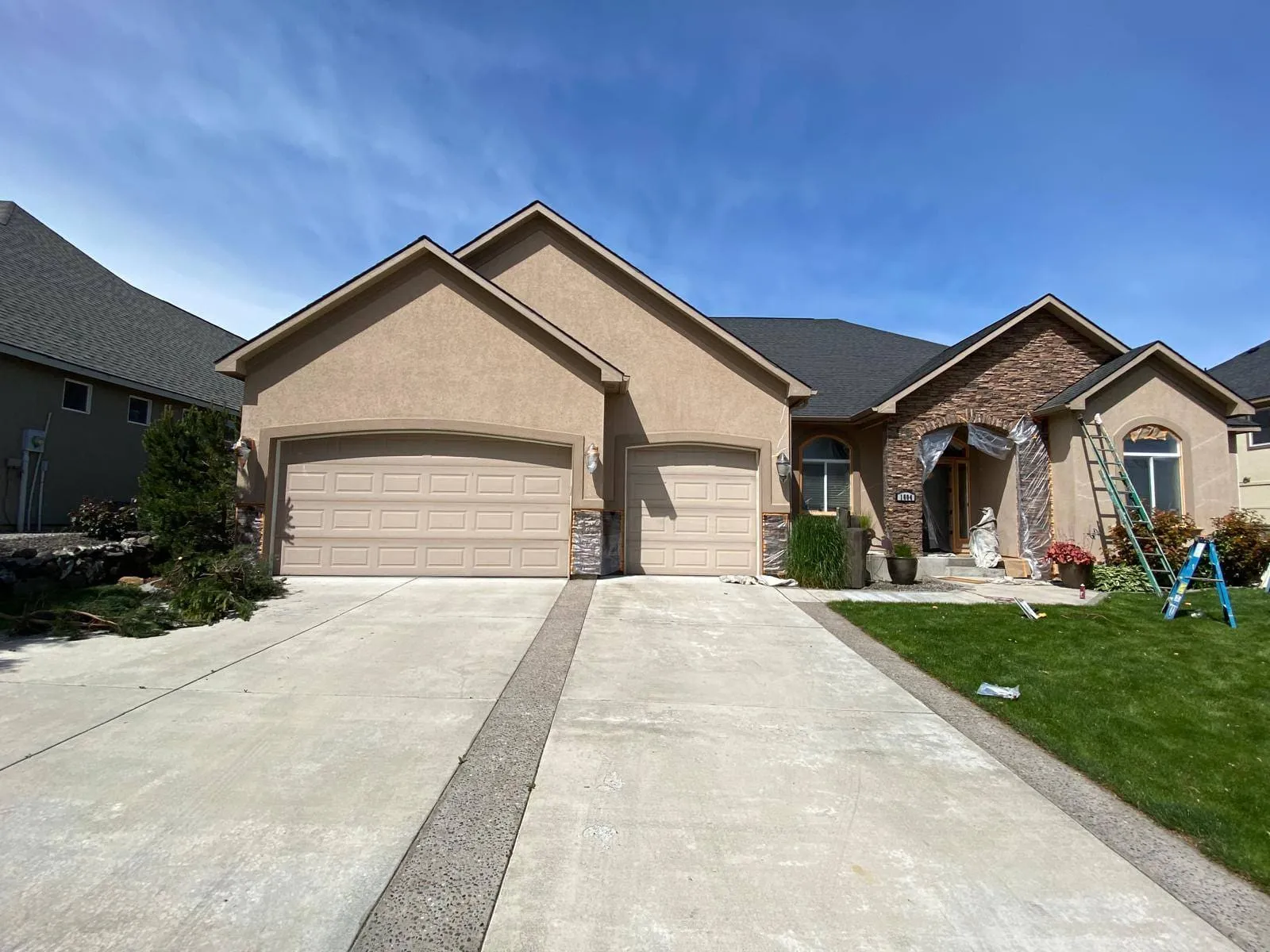 Tan stucco home with a fresh coat of paint and clean matching trim