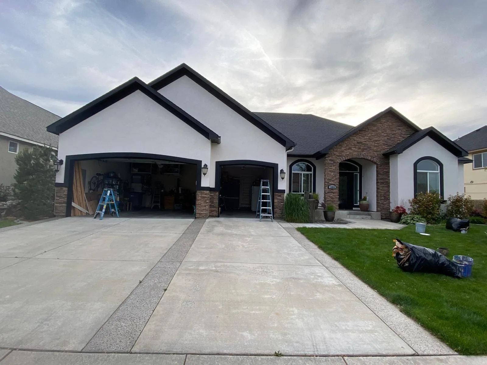 Two-story residential home with freshly painted siding and matching trim